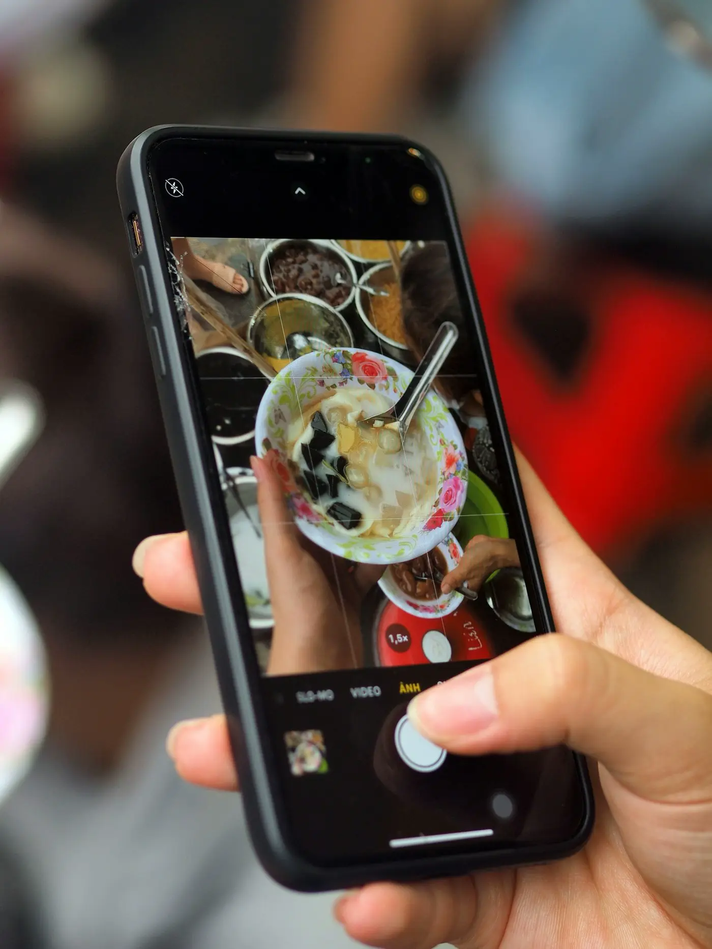 A person photographing a bowl of food