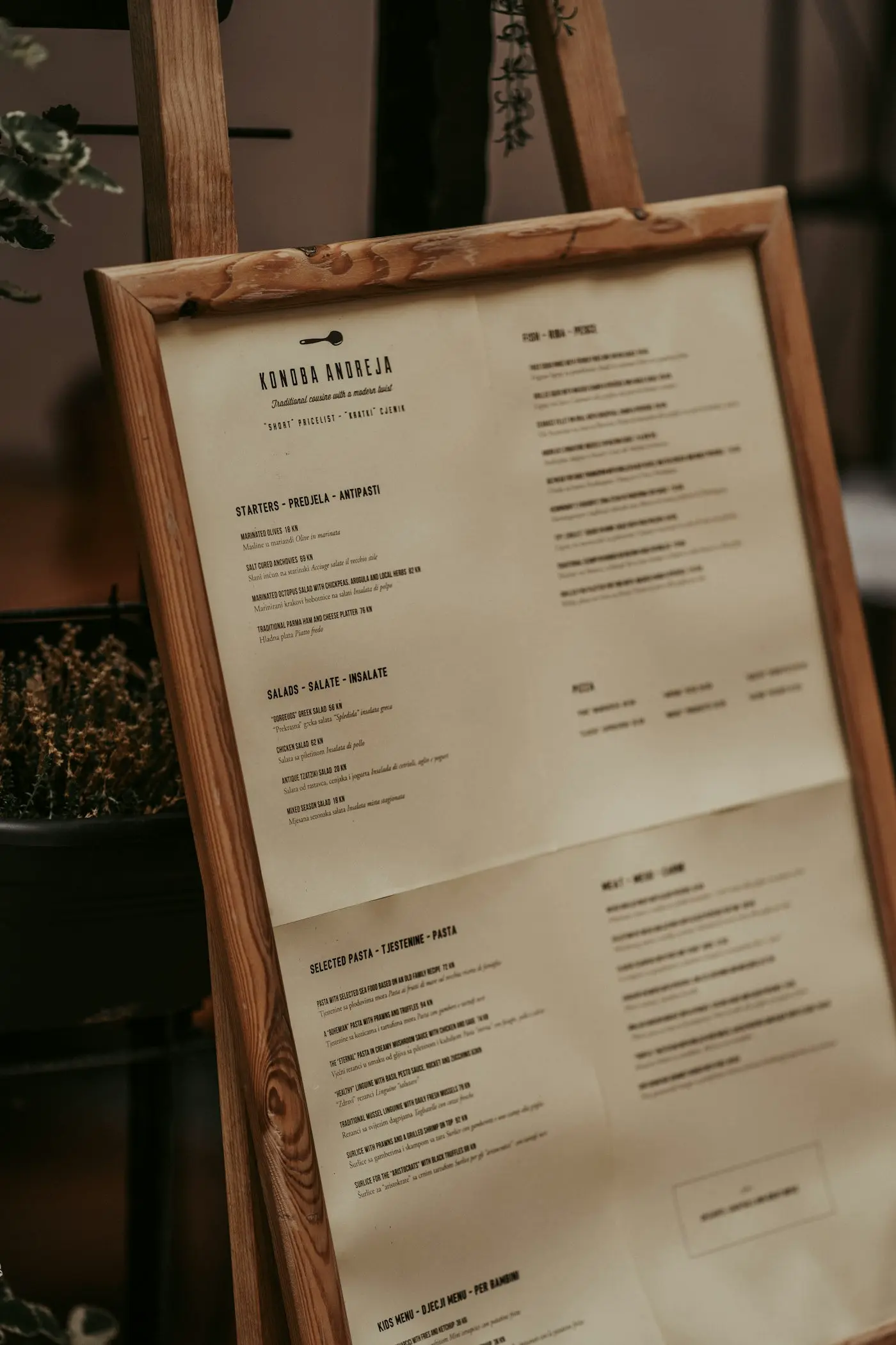 A printed restaurant menu open on a wooden table