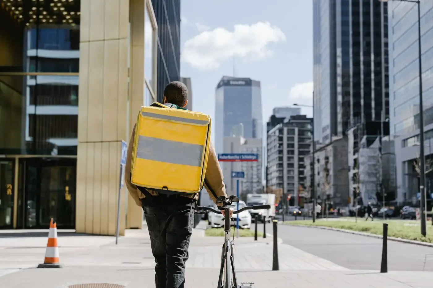 A courier with a food delivery bag